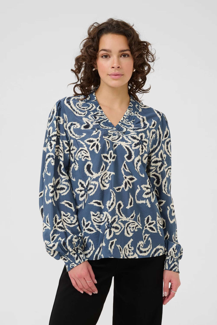 Dahlia blouse with long sleeves and elegant lace pattern, featuring a split neckline and decorative buttons. French chic fashion.
