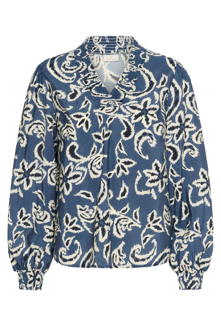 Blouse Dahlia bleu avec manches longues en tissu ajouré, encolure fendue et motifs floraux blancs, chic et décontractée.