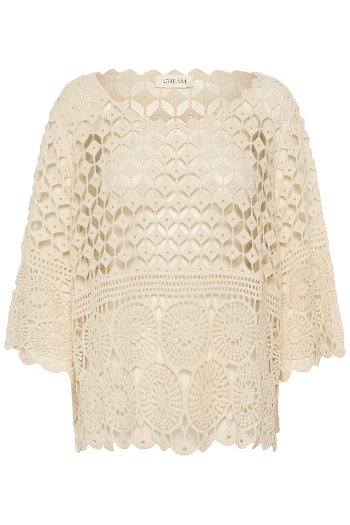 Blouse Gina en crochet ajouré avec manches trois-quarts, ourlet festonné et motif texturé bohème.