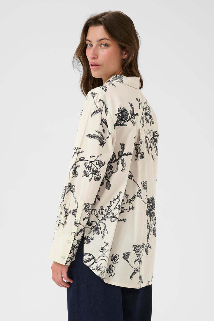 Blouse Sveja à imprimé floral noir et blanc, coupe fluide en vue de dos, style élégant et polyvalent pour bureau et sorties.