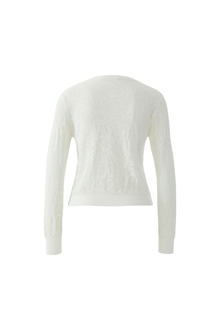 Cardigan en maille ajourée à volants de dos, montrant la texture délicate et le style ajusté, parfait pour un look raffiné.