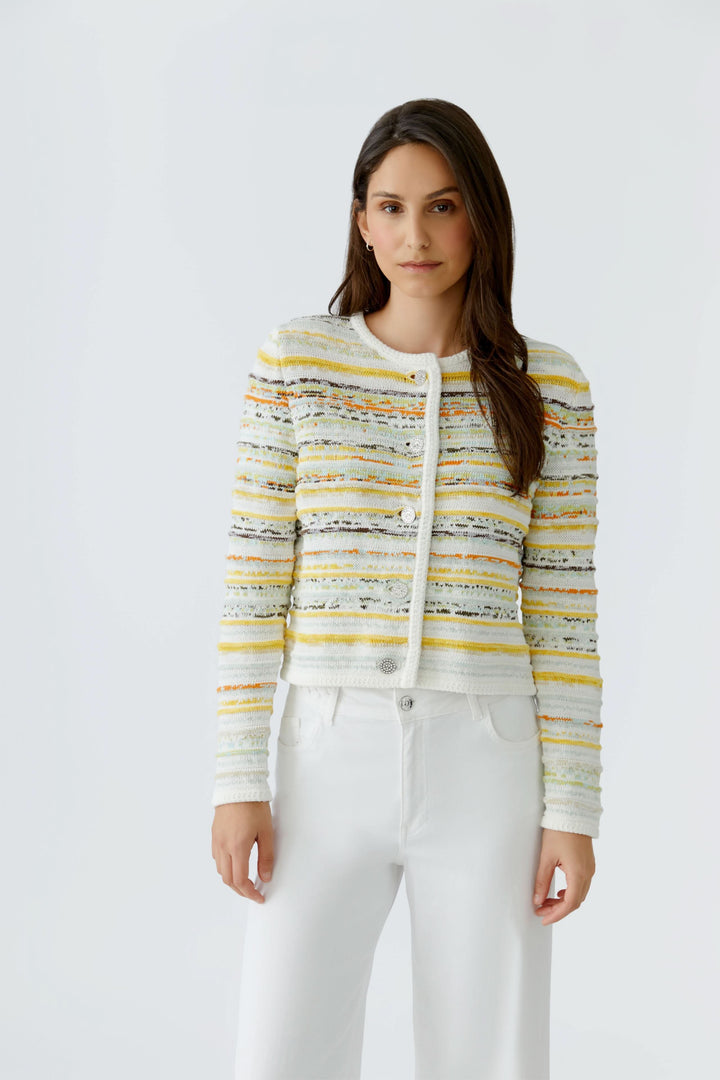 Cardigan en maille à rayures boutonné porté par un modèle, manches longues, encolure ronde, pour une allure élégante et structurée.