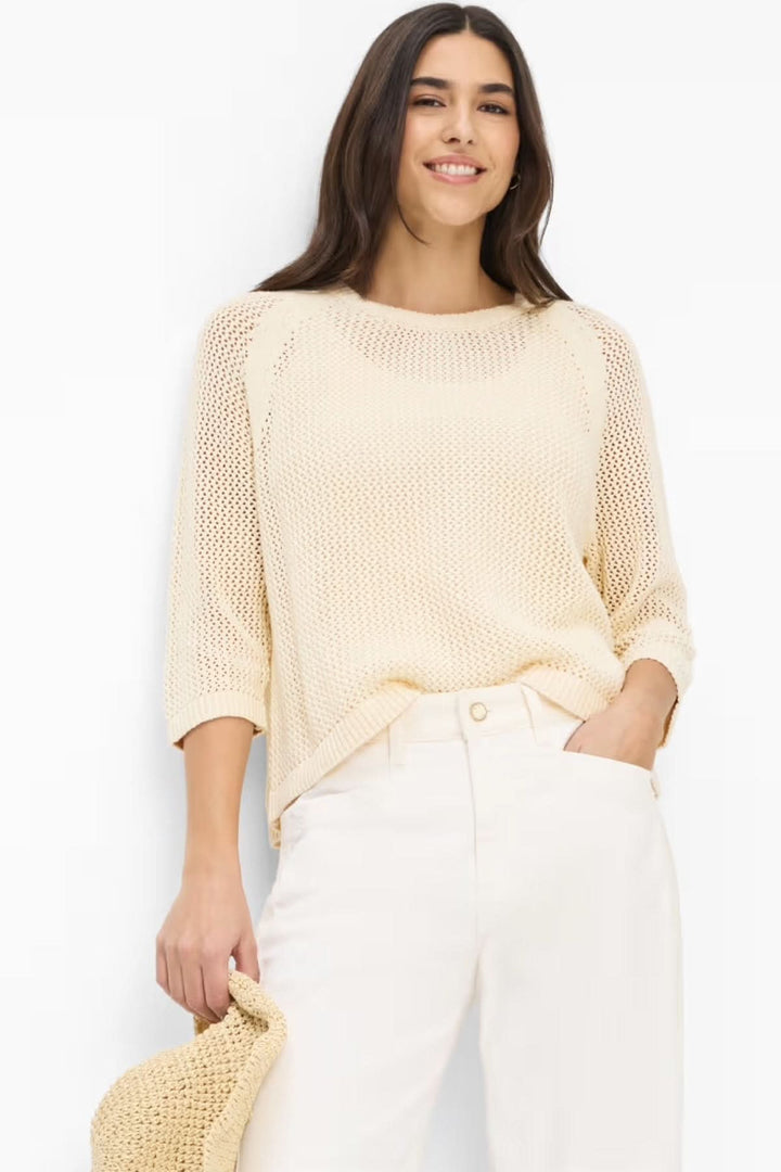 Femme portant le chandail manches trois-quarts NALA en tricot texturé ajouré, couleur crème, coupe décontractée et légère.