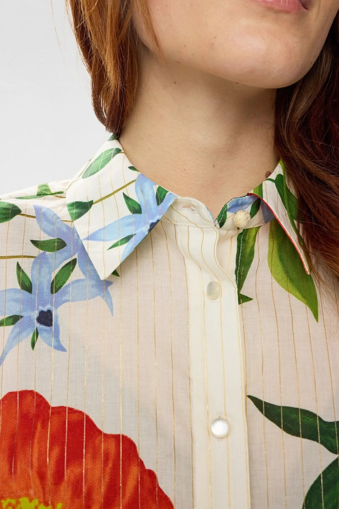 Chemise fluide imprimée à manches volantées avec col classique et motifs floraux, élégante et féminine.