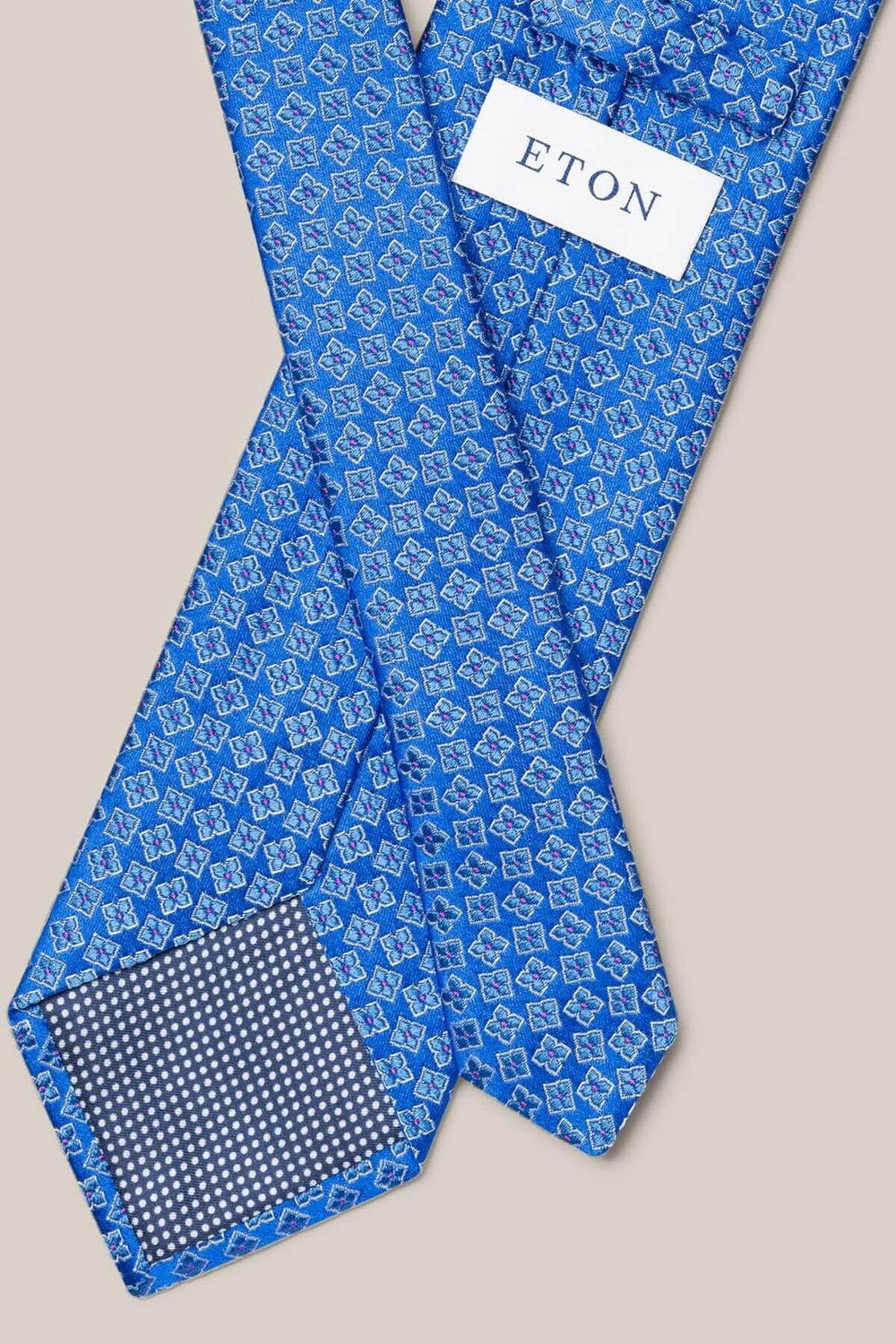 Cravate en soie bleu avec motif géométrique élégant, parfaite pour les occasions formelles.