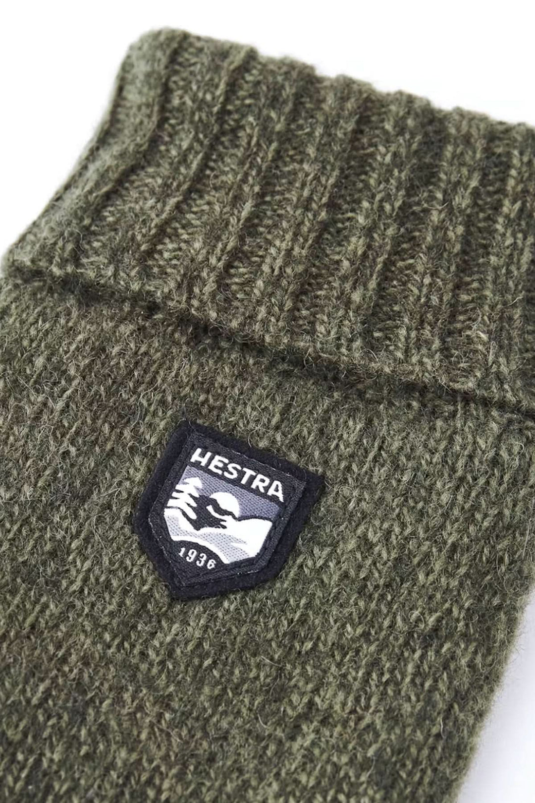Mitaine en laine basique de couleur verte avec logo Hestra sur le revers côtelé.