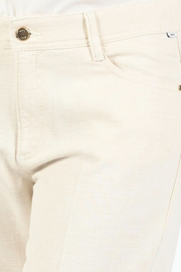 Pantalon MAINE lurex doré naturel, coupe évasée, couleur beige, avec détails élégants et poches fonctionnelles.