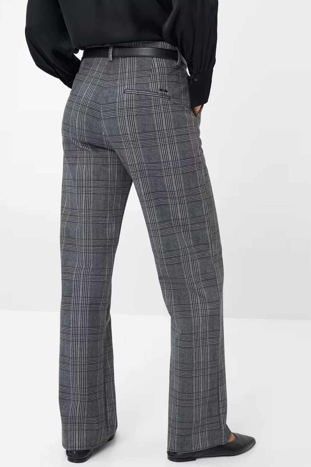 Pantalon Maine à carreaux avec coupe ample et fluide, porté avec chemise noire et chaussures élégantes, vue de dos.