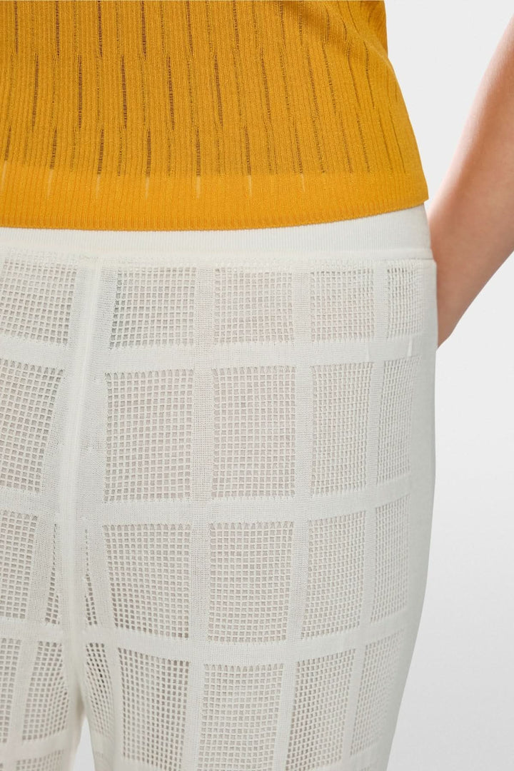 Pantalon Welkom large en maille ajourée avec transparence et coupe large, confort moderne et élégant en détail.