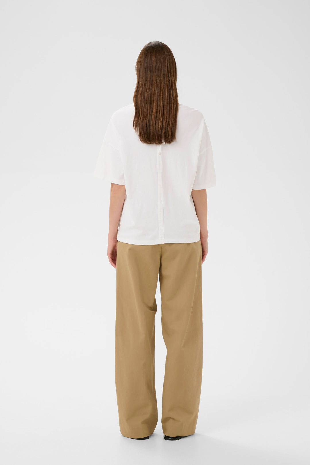 Femme portant le T-shirt Sophie fluide à nouer au dos, vu de dos, avec une coupe ample et élégante.