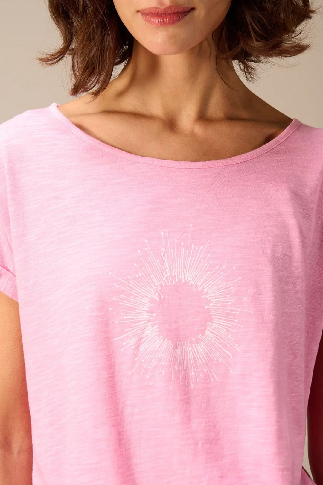 Femme portant un T-shirt à manches courtes coupe décontractée rose avec motif graphique, tissu léger et confortable pour style quotidien.