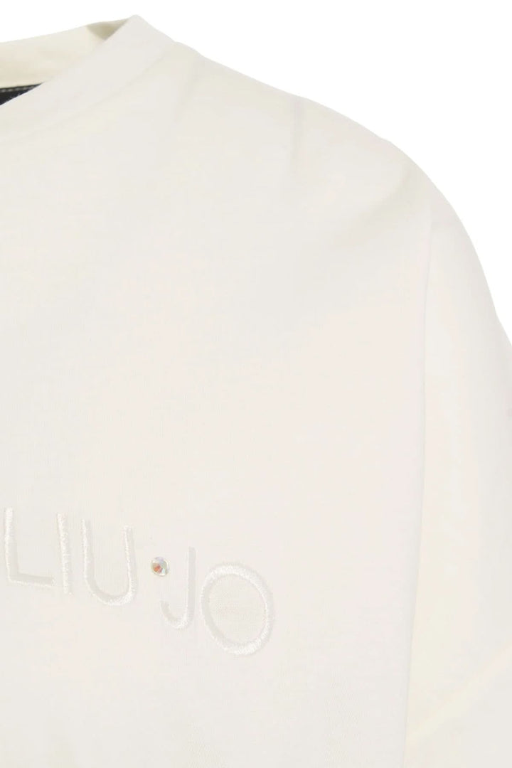 T-shirt oversize avec logo brodé en coton doux, détail du logo sur la poitrine, coupe décontractée et ourlet élastiqué élégant.