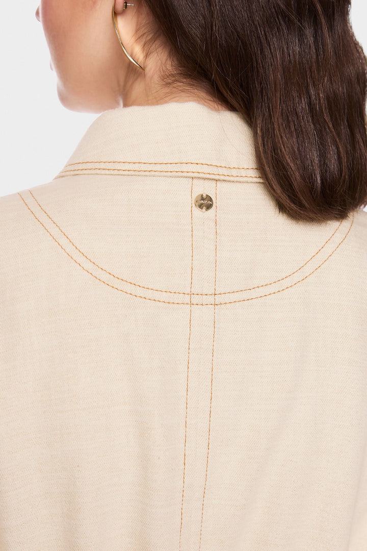 Détail de la couture et du col structuré de la veste légère à taille ajustable en beige.