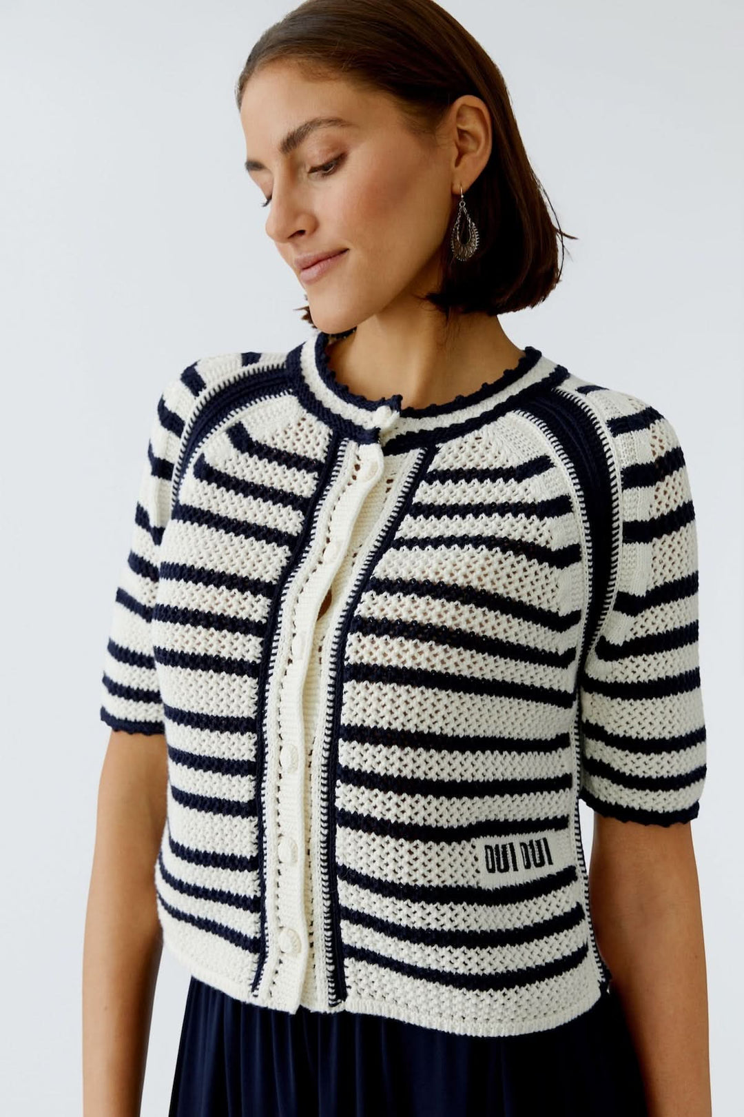 Veste tricot à rayures avec bordures contrastantes, style structuré et raffiné, idéale pour tenues chics et décontractées.