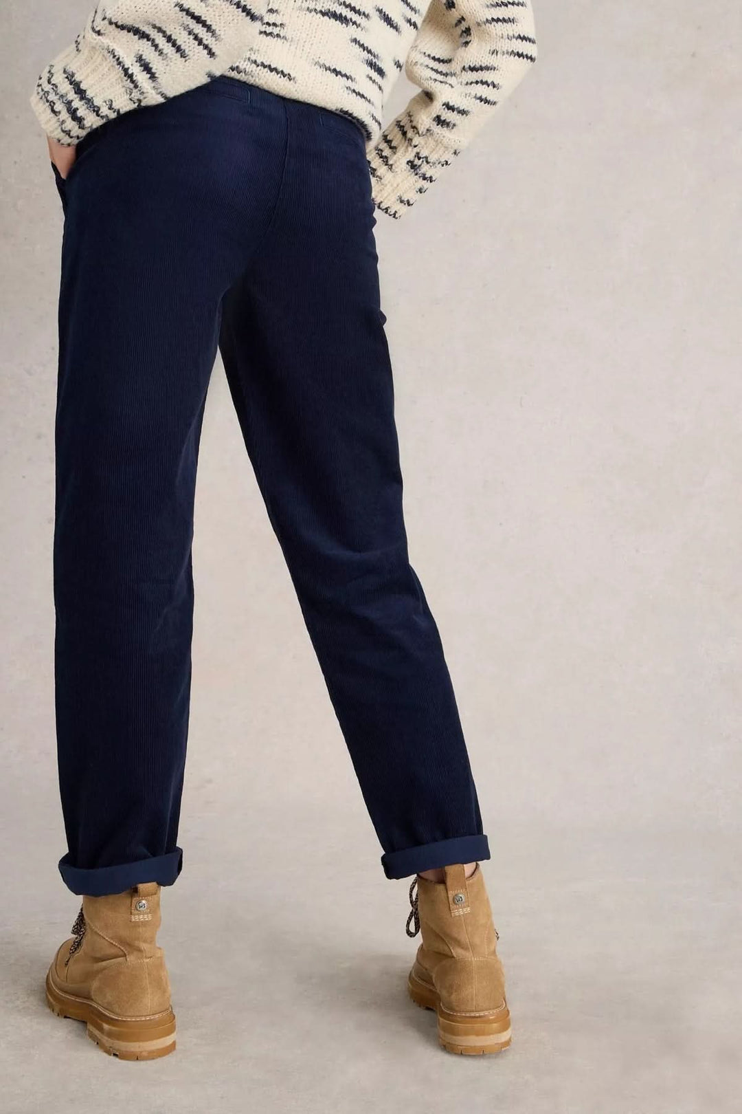 Mannequin portant le Pantalon Twister en velours côtelé bleu avec coupe légèrement fuselée et grandes poches, style casual-chic.