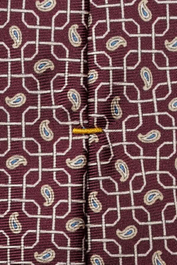 Cravate à motif géométrique en soie italienne avec motif raffiné et texture lustrée, idéale pour occasions formelles.
