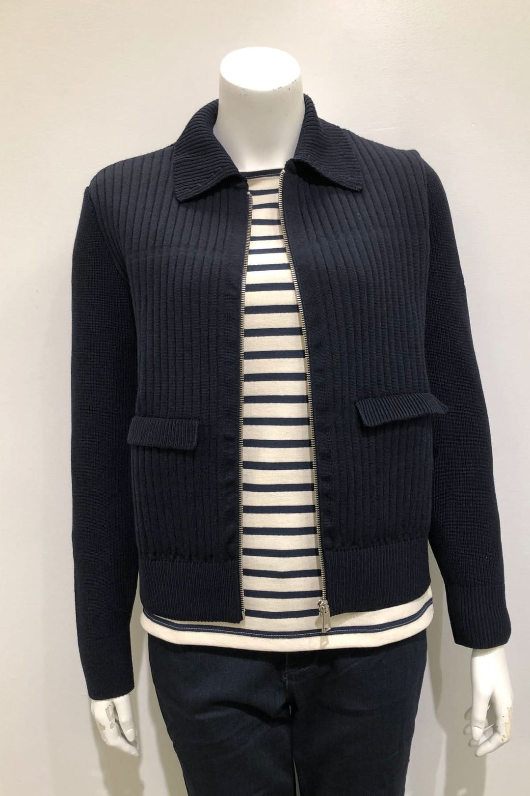 Mannequin wearing Cardigan zippé CHATEL marine, with ribbed texture, classic collar, over a striped navy and cream t-shirt.