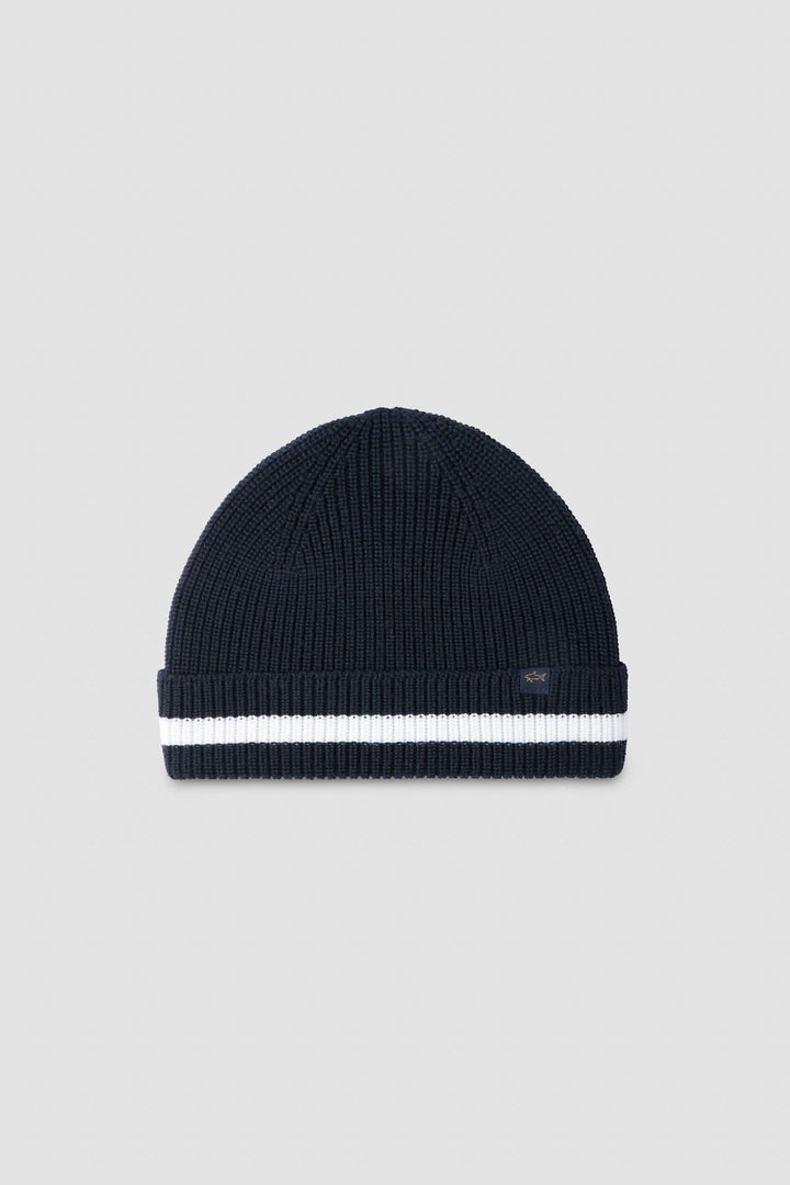Tuque en tricot côtelé bleu marine avec bande blanche pour un style hivernal moderne et élégant.