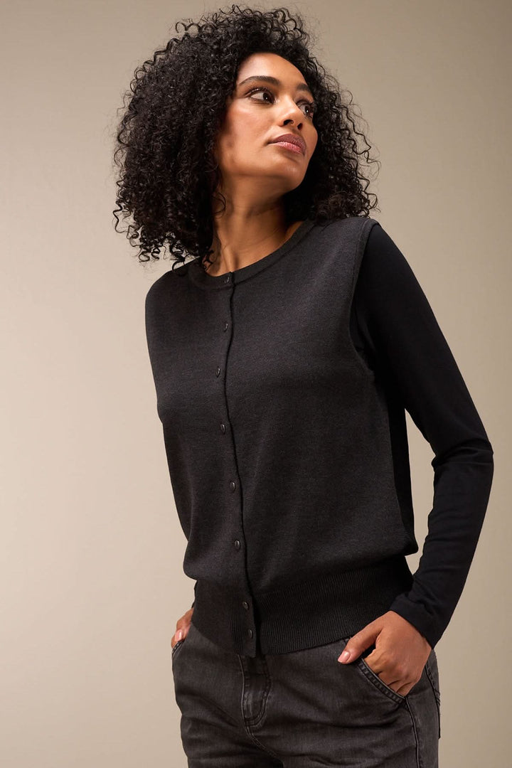 Veste sans manches en maille douce, coupe droite et boutons-pression, style chic et polyvalent.